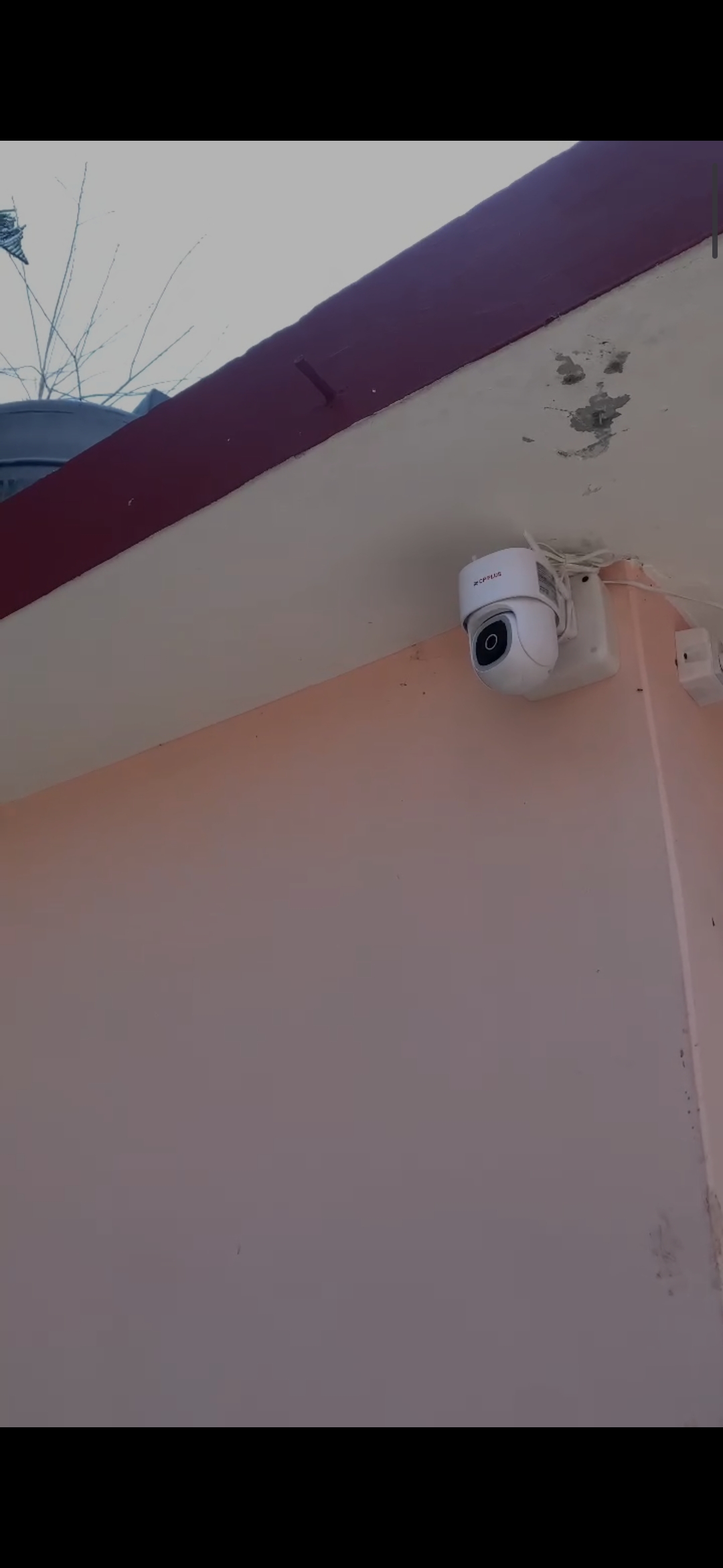 Security camera mounted on a dark wall